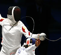 China's Xiaojuan Luo (L) competes against France's Laura Flessel-Colovic during the women's fencing epee team final event at the World Fencing Championship in Turin October 6, 2006. China won the gold medal. 