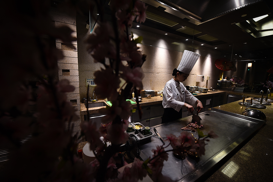 Young female chef performs for five-star hotel guests