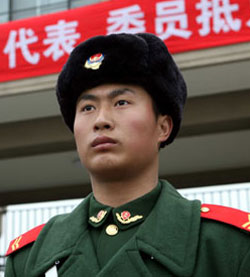 An armed policeman is on duty at the Capital International Airport in Beijing March 1, 2007. The security is beefed up as members of the Chinese People's Political Consultative Conference arrived for an annual session. [Xinhua]