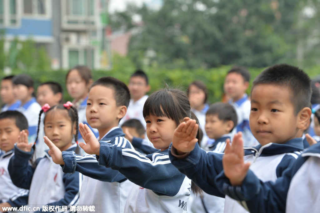 Students demonstrate new official anti-smoking gestures