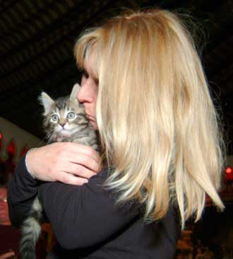 A Dallas, Texas resident Julie, who paid $50,000 to have her cat cloned is presented with Little Nicky the cloned cat in San Francisco on December 10, 2004. The Dallas-area resident stored her cat Nicky's tissue gene bank at Genetic Savings & Clone, Inc. in California and on December 10, she became the first owner of a commercially cloned feline, dubbed Little Nicky. [Reuters]