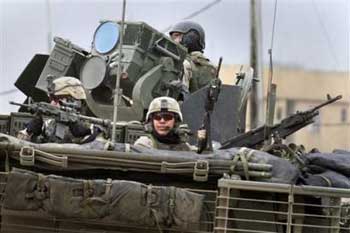 U.S. Army 1st Battalion, 24th Infantry Regiment soldiers pursue attackers in their Stryker combat vehicle after a firefight in Mosul, Iraq Sunday, Feb. 6, 2005. Their convoy was attacked by insurgents firing rocket-propelled grenades, mortars and small arms, but there were no casualties. [AP]