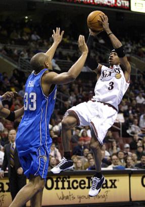 Orlando Magic's Grant Hill (33) defends as Philadelphia 76ers' Allen Iverson goes up for a shot during the first half Saturday, Feb. 12, 2005, in Philadelphia. [AP]