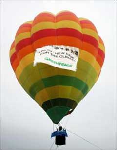 A Greenpeace ballon celebrates the signing of the Kyoto Protocol over that city. The Australian government is resisting renewed pressure to ratify and implement the Kyoto Protocol as it came into effect amid claims Australia's refusal to join will damage its international reputation. [AFP]