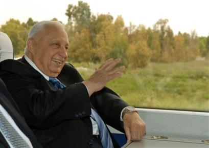 In this photo released by the Israeli Government Press Ofiice Israeli Prime Minister Ariel Sharon gestures during a train ride from the southern town of Ashkelon to Jerusalem Monday April 18, 2005. Sharon on Monday said he is considering delaying Israel's planned withdrawal from the Gaza Strip this summer by three weeks after a top official said settlers shouldn't be moved during a Jewish mourning period that marks the destruction of the biblical temples. (AP