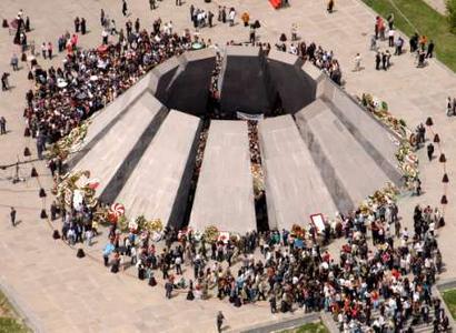 Armenians visit the memorial to the dead to mark the 90th anniversary of the mass killing of Armenians in Yerevan, April 24, 2005. Hundreds of thousands of people clutching tulips, carnations and daffodils climbed a hill in Armenia's capital on Sunday to lay wreaths and remember the 1.5 million they say were killed 90 years ago in Ottoman Turkey.From the top the crowds could see the heights of Mount Ararat now in eastern Turkey, the region where Armenia says its people were slaughtered in a deliberate genocide during the chaos surrounding the disintegration of the Ottoman Empire. The mountain is a potent symbol for the Christian nation but it lies out of reach across a fortified frontier. REUTERS