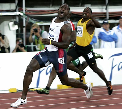 Justin Gatlin of the U.S. (front) wins the men's 100 metres final at the world athletics championships in Helsinki August 7, 2005. Behind him is Dwight Thomas of Jamaica. Gatlin won the men's 100 metres final gold medal in 9.88 seconds at the world athletics championships on Sunday. Michael Frater of Jamaica took silver and Kim Collins of St Kitts and Nevis won the bronze. [Reuters]