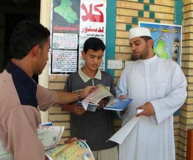 An election worker distributes information on Iraq's draft constitution in the town of Kut, 160 km (100 miles) south of Baghdad October 8, 2005.