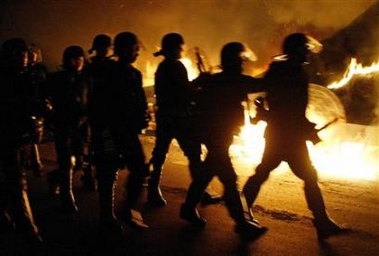 Riot police advance during clashes with French youths in Paris suburb of Aulnay sur Bois, early November 3, 2005, in a seventh night of rioting. Street fighting, sparked by the deaths of two teenagers electrocuted while apparently fleeing police during a local disturbance, spread to other parts of the poor suburbs ringing the capital to the north and the east. (Victor Tonelli/Reuters)