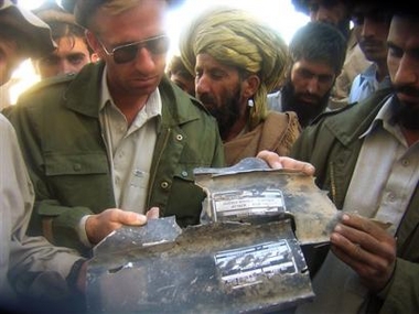 People show wreckage of a missile they found in the house where authorites reportedly killed five people including a key associate of al-Qaida Hamza Rabia, Thursday in Hesory 25 kilmeters (15 miles) east of Miran Shah in Pakistani tribal along the Afghanistan border, Sunday, Dec 4, 2005. 