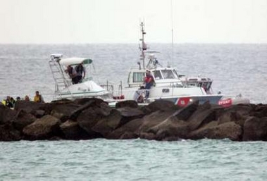 Rescuers search the crash site after a seaplane crashed and sank off Miami Beach into the city's main shipping channel, December 19, 2005.