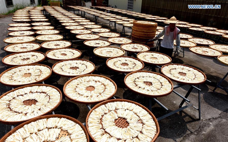 Workers make Kuanmiao noodles in SE China's Taiwan