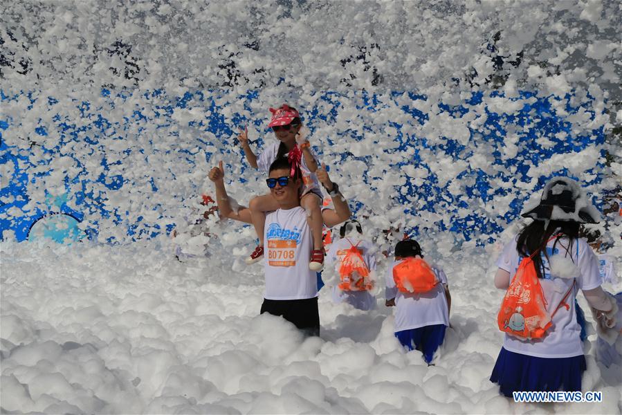 People take part in bubble run in Beijing