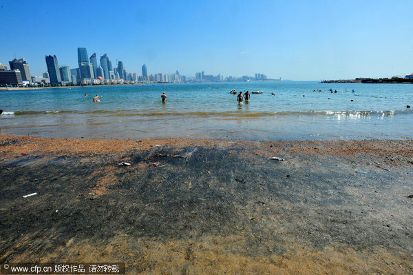 E China beach covered by unknown black substance