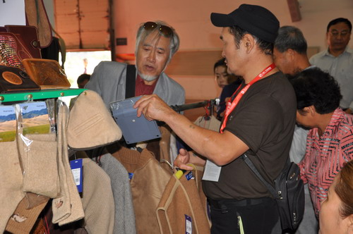 A male salesperson from Mongolia offers a price