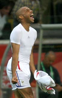 France's Thierry Henry celebrates, as Brazil coach Carlos Alberto Parreira walks in the background, after France defeated Brazil in their World Cup 2006 quarter-final soccer match in Frankfurt July 1, 2006. 