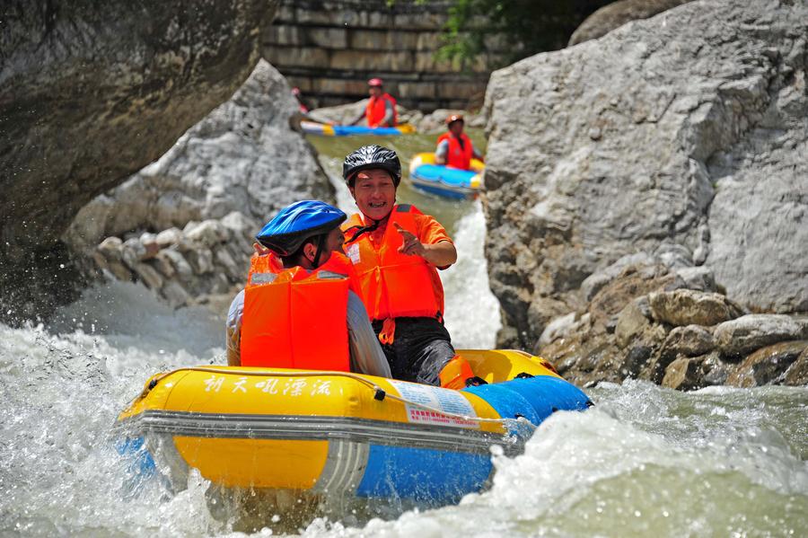 Tourists drift by rafts at China's Chaotianhou scenery spot