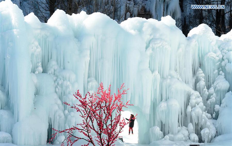 People visit frozen waterfall in N China