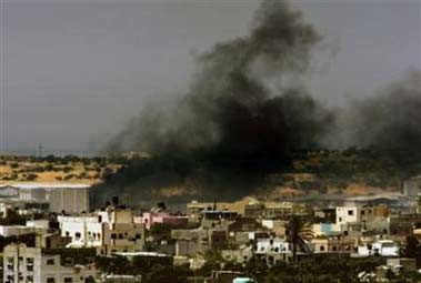 Black smoke is seen during an Israeli bombardment over the town of Beit Lahiya, northern Gaza Strip July 8, 2006. UN chief Kofi Annan called for an immediate stop to what he called Israel's 'disproportionate use of force' in Gaza but also pressed for the release of an Israeli soldier snatched by Palestinian militants. (Yannis Behrakis/Reuters)