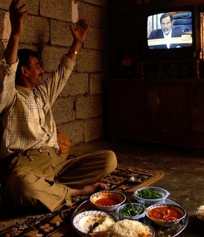 Taxi driver Khatab Ahmed rejoices as death penalty is told to former leader Saddam Hussein, in Kirkuk, 290 kilometers (180 miles) north of Baghdad, Nov. 5, 2006. Iraq's High Tribunal on Sunday found Saddam Hussein guilty of crimes against humanity and sentenced him to hang, as the visibly shaken former leader shouted 'God is great!' Ahmed's brother and uncle were arrested by Saddam's security forces in the 1980s and disappeared forever and his two cousins died in a 1991 Kurdish uprising. (AP