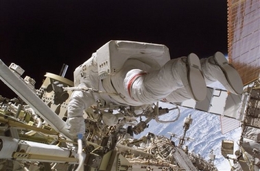 In this photo provided by NASA, space shuttle Discovery astronaut Robert L. Curbeam, Jr. participates in the mission's first of three planned sessions of extravehicular activity (EVA) as construction resumes on the international space station. Tuesday Dec. 12, 2006. (AP