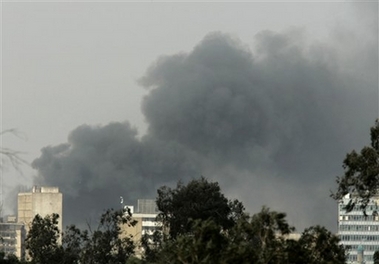 Thick smoke rises over central Baghdad, Iraq, Monday, March 5, 2007. A suicide car bomber struck a busy commercial district Monday, killing at least 16 people and injuring more than 30, police said. (AP