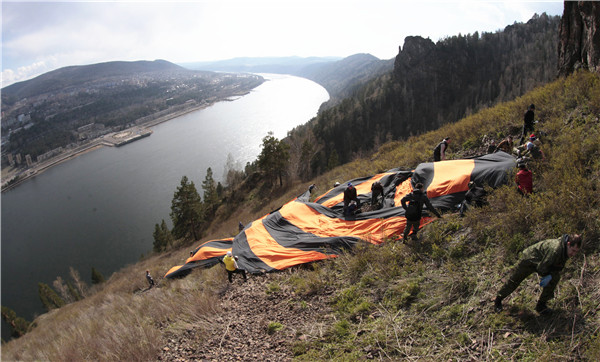 People mark upcoming Victory Day by placing giant St. George's Ribbon