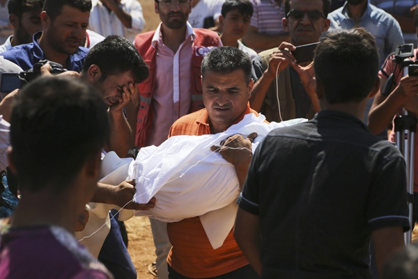 Drowned refugee boys buried in Syria; crackdown crumbles in Hungary